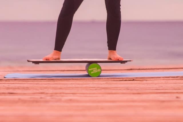 A woman balancing over a wooden board