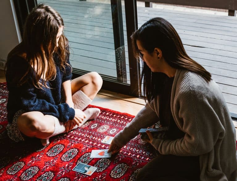 Two young women testing their intuition at cards
